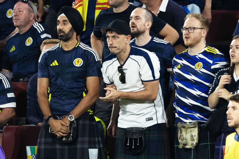 Richard Gadd in a white Diadora top with other Scotland fans