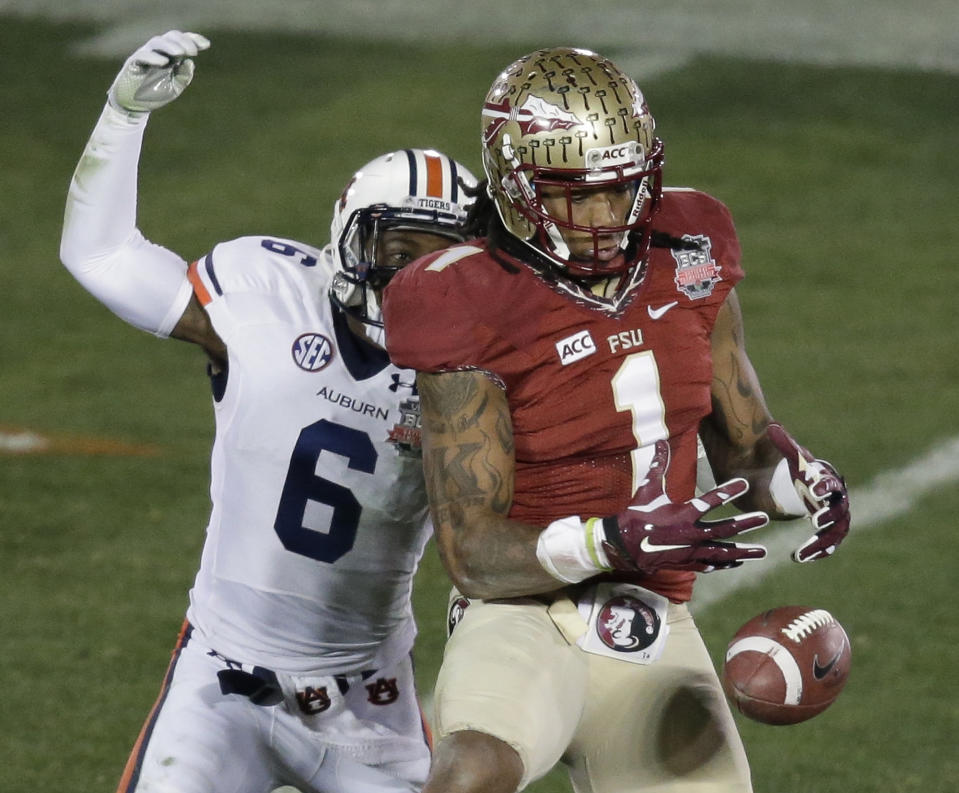 Florida State's Kelvin Benjamin drops a pass with Auburn's Jonathon Mincy (6) defending during the second half of the NCAA BCS National Championship college football game Monday, Jan. 6, 2014, in Pasadena, Calif. (AP Photo/Gregory Bull)