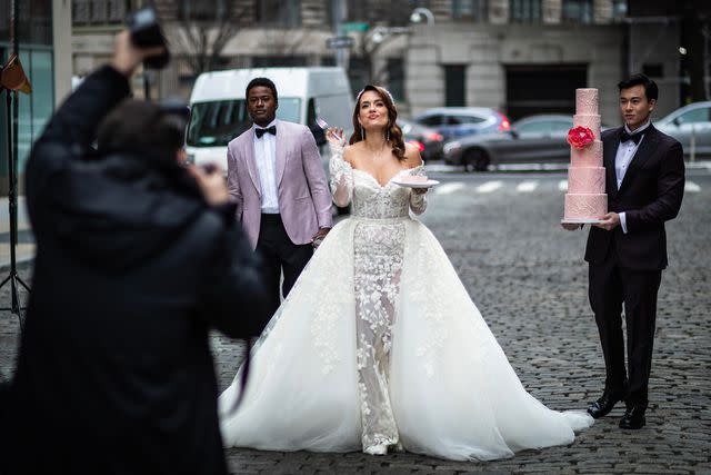 <p>Nick Hiras</p> Torrey DeVitto walks down New York street in wedding dress