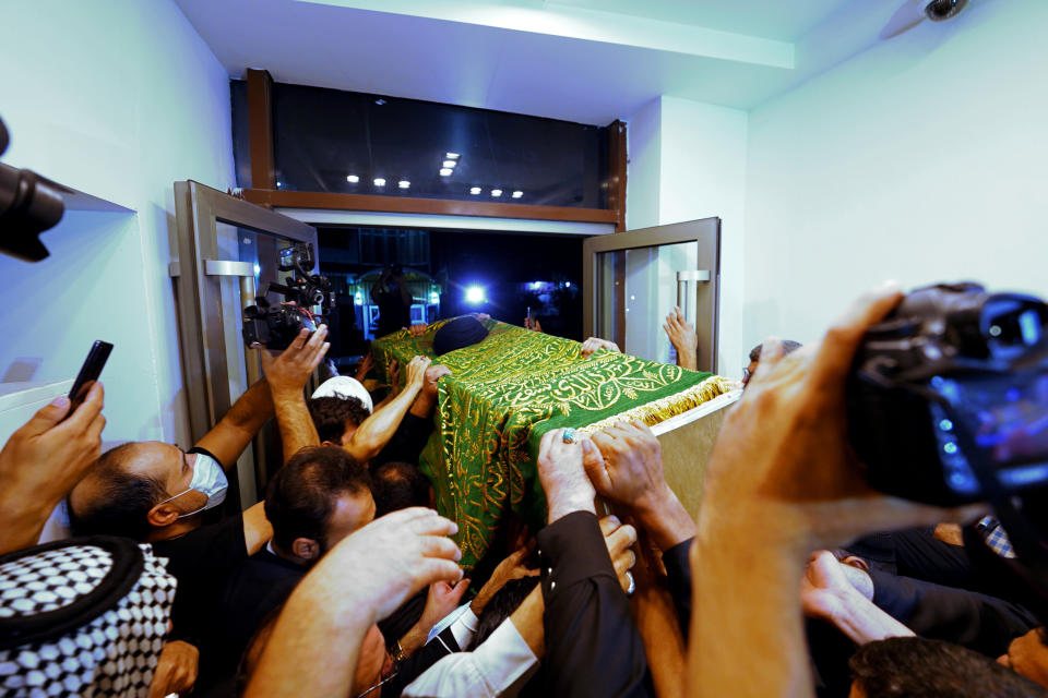 Mourners escort the coffin of Grand Ayatollah Sayyid Mohammed Saeed al-Hakim to his home in Najaf, Iraq, Friday, Sept. 3, 2021. Mohammed Saeed al-Hakim, one of Iraq's most senior and influential Muslim Shiite clerics, has died, members of his family said. He was 85. (AP Photo/Anmar Khalil)
