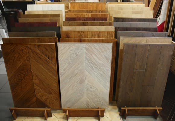 Three rows of different types of hardwood flooring displayed in store.