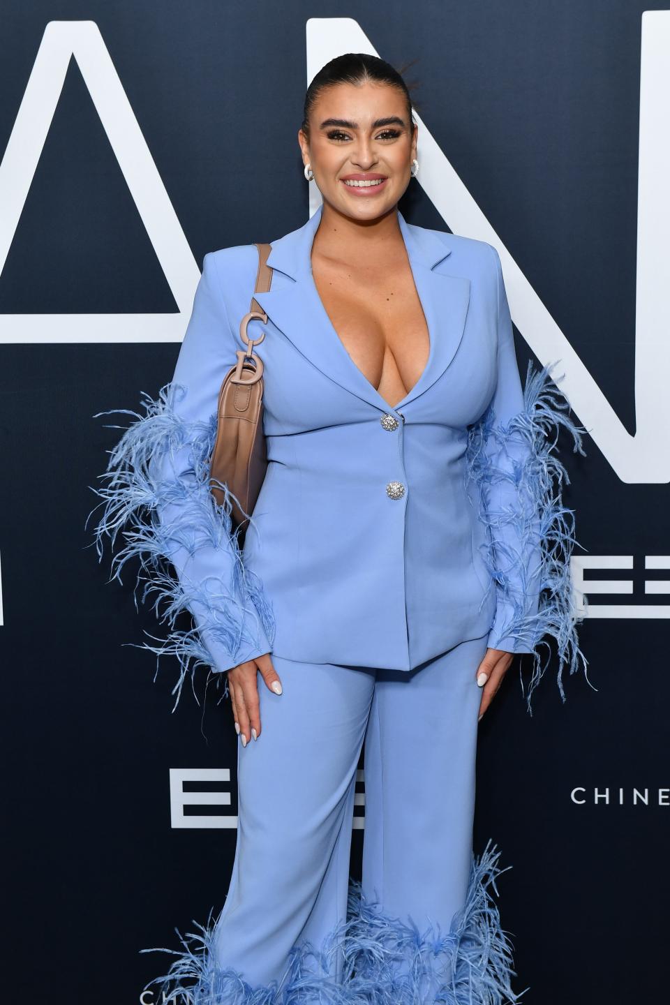 Kalani Hilliker wearing a blue suit and posing for a photo.