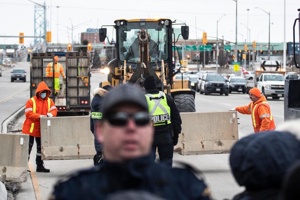 Roadblocks are being installed during an anti-mandate protest on Huron Church Road in Windsor, ON., on Feb. 12, 2022.