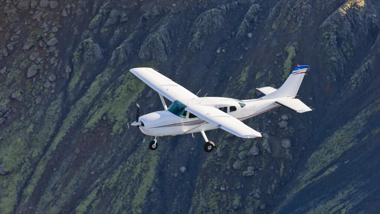  Flying low over moss covered mountains, South Coast, Iceland. 