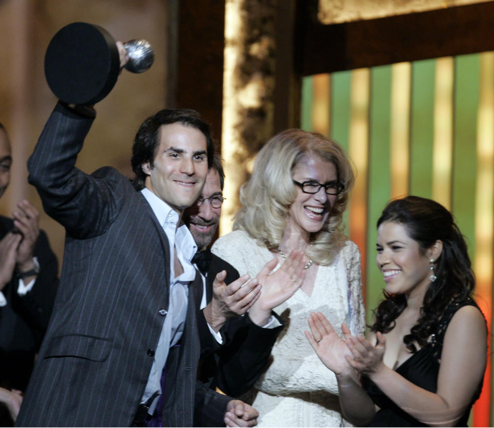 FILE - This March 2, 2007 file photo shows Silvio Horta, producer of "Ugly Betty," accepting the award for outstanding comedy series with star America Ferrara, right, at the 38th NAACP Image Awards in Los Angeles. Horta died in Miami on Tuesday, Jan. 8, 2020. He was 45. (AP Photo/Chris Carlson, File)
