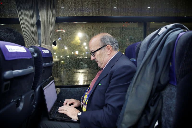 Reuters correspondent Pullella writes aboard a bus taking the Vatican press corps to Tokyo airport