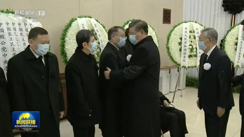 In this image taken from video footage run by China's CCTV, Chinese President Xi Jinping, second from right, and his predecessor Hu Jintao, right, meet with family members of former president Jiang Zemin as they pay respect to Jiang before sent for cremation at Babaoshan cemetery, at a military hospital in Beijing, Monday, Dec. 5, 2022. Chinese President Xi Jinping and other current and previous top officials paid their respects Monday to former leader Jiang Zemin, who died last week at age 96. (CCTV via AP)