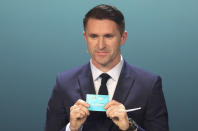 Irish soccer player Robbie Keane draws Germany during the UEFA Euro 2020 European soccer championship qualifying draw at the Convention Centre in Dublin, Ireland, Sunday, Dec. 2, 2018. (AP Photo/Peter Morrison)