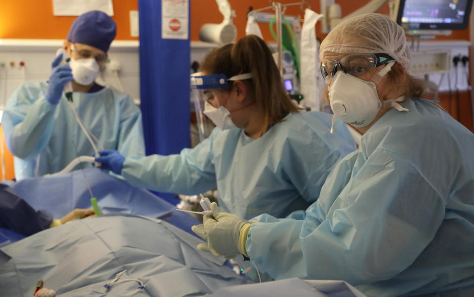 Critical Care Consultant Jenny Townsend, right, works with Critical Care staff to carry out a tracheostomy procedure on a COVID-19 patient on the Christine Brown ward at King's College Hospital in London, Wednesday, Jan. 27, 2021. (AP Photo/Kirsty Wigglesworth, Pool)