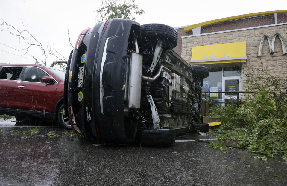 A car is flipped at McDonalds on Old Spanish Trail after an apparent tornado touched down in south Slidell, La., Wednesday, April 10, 2024. (Scott Threlkeld/The Times-Picayune/The New Orleans Advocate via AP)