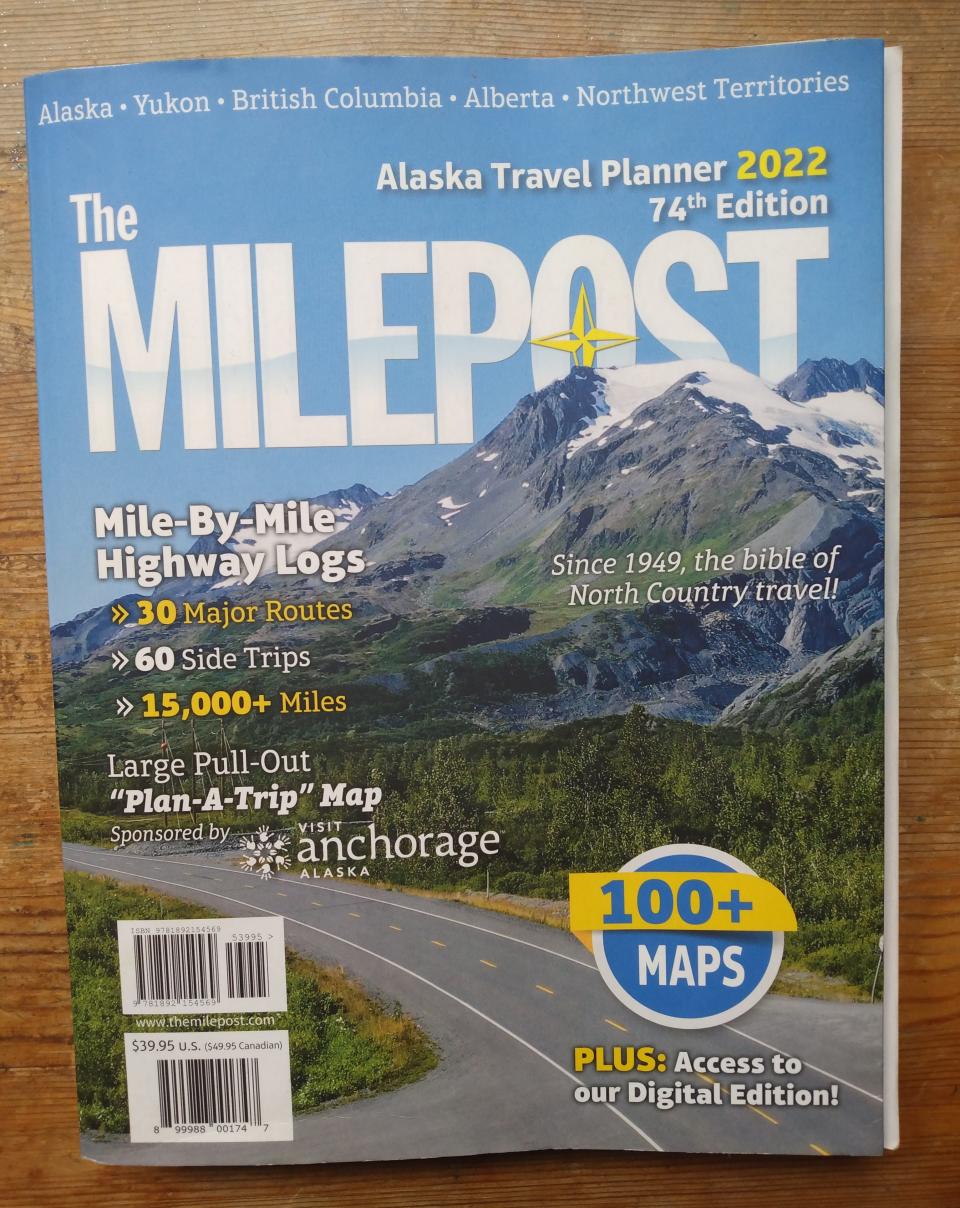 A book titled "The Milepost" with a mountain on the cover.