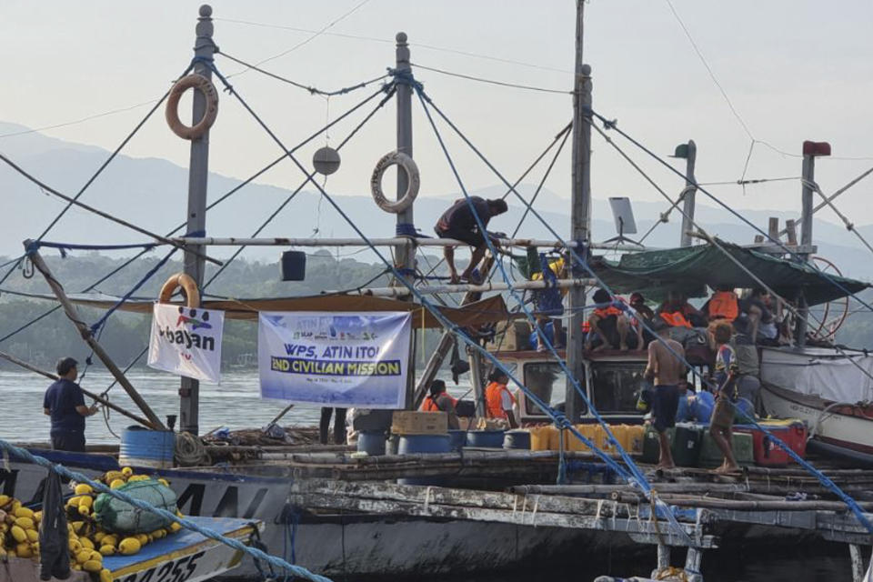 In this photo provided by Atin-Ito/Akbayan Party, activists and volunteers on fishing boats prepare for their journey at Masinloc, Zambales province, northwestern Philippines on Wednesday May 15, 2024. A flotilla of about 100 mostly small fishing boats led by Filipino activists sailed Wednesday to a disputed shoal in the South China Sea, where Beijing's coast guard and suspected militia ships have used powerful water cannons to ward off what they regard as intruders. (Atin-Ito/Akbayan Party via AP)