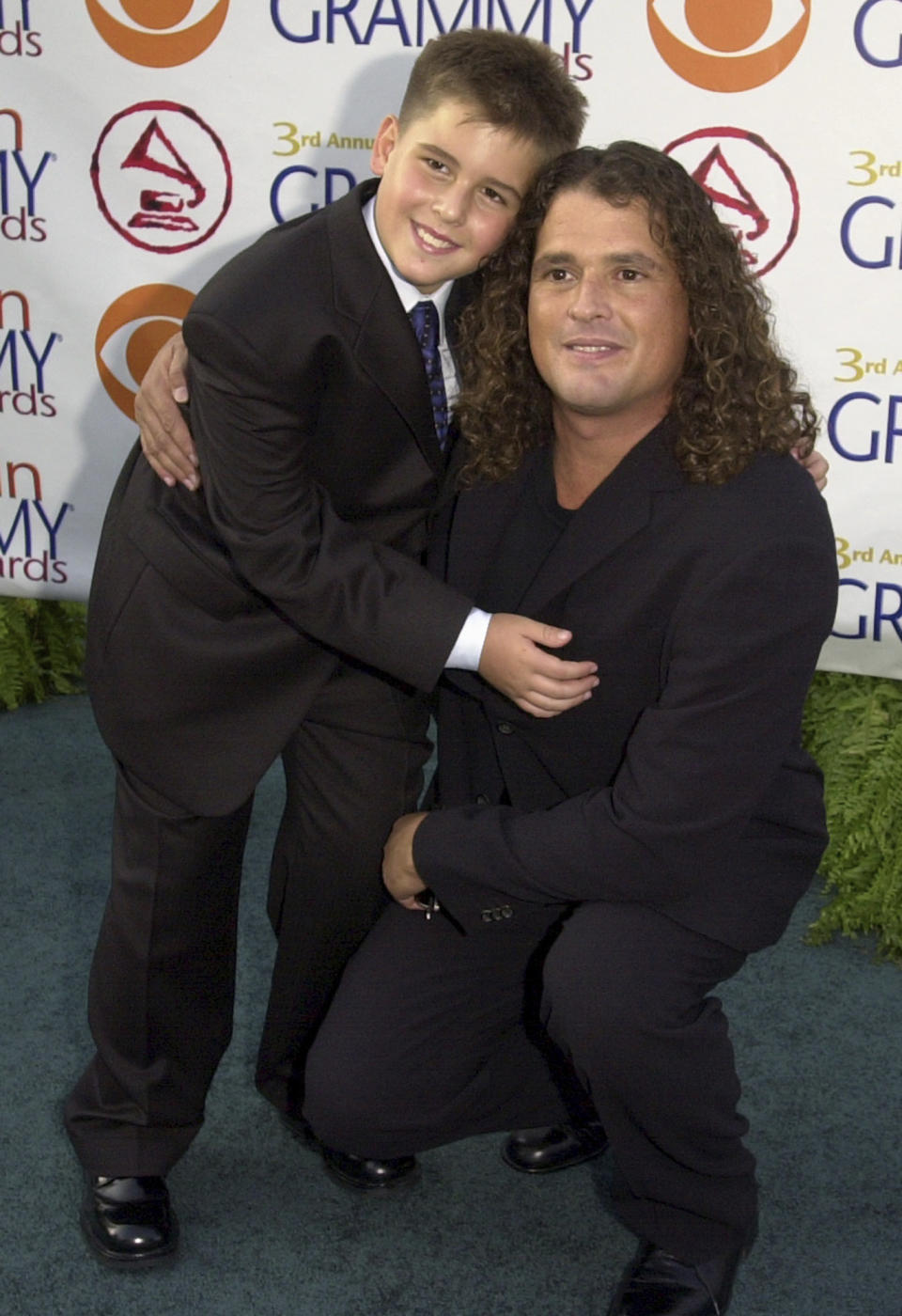 ARCHIVO - Carlos Vives, de Colombia, llega con su hijo Carlos Enrique a la 3a entrega anual del Latin Grammy el miércoles 18 de septiembre de 2002, en el distrito de Hollywood en Los Angeles. Tras ser el artista más nominado de la 1ra edición de los Latin Grammy, Vives es la Persona del Año de la Academia Latina de la Grabación 2024, anunció la academia el miércoles 22 de mayo de 2024. (Foto AP/Kim D. Johnson, archivo)