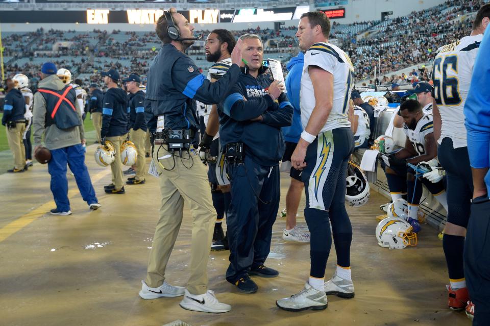 Los Angeles Chargers quarterback Philip Rivers (17) talks with offensive coordinator Shane Steichen, left, and offensive line coach Pat Meyer on the sideline during the second half of an NFL football game against the Jacksonville Jaguars Sunday, Dec. 8, 2019, in Jacksonville, Fla. (AP Photo/Phelan M. Ebenhack)