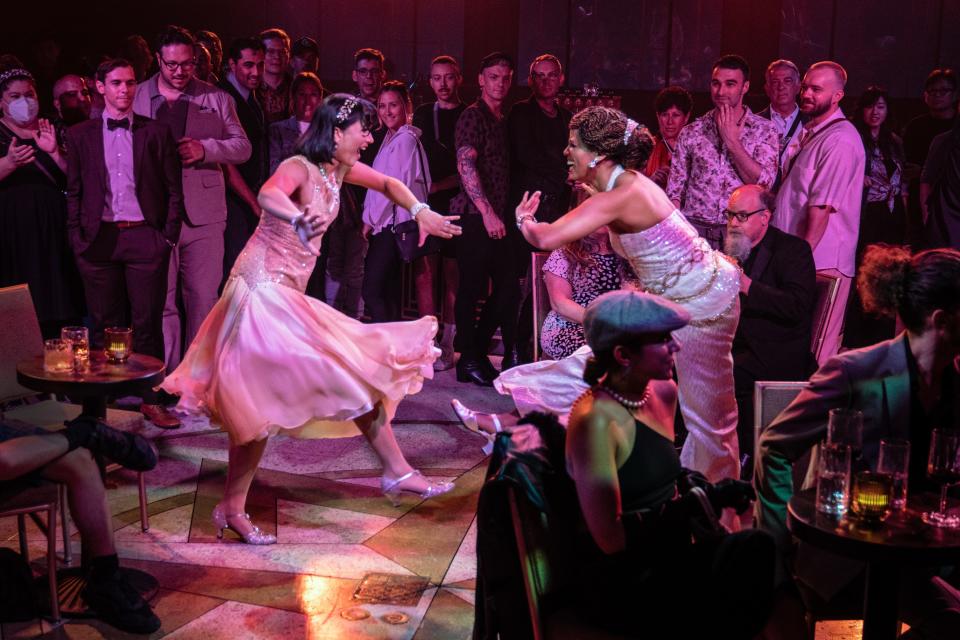 Jillian Anne Abaya, left, and Stephanie Rocío dance as theatergoers look on in the immersive "The Great Gatsby."