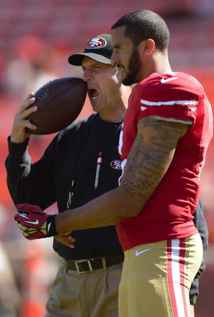 Jim Harbaugh, left, and Colin Kaepernick chat when they were together with the San Francisco 49ers (Getty Images).