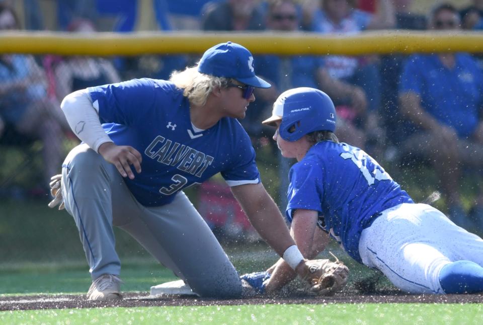 Lake Center Christian's Matt Warder beats the tag of Tiffin Calvert's Mason Johnson in the first inning of a Division IV baseball regional semifinal, Thursday, June 1, 2023, at Louisville.