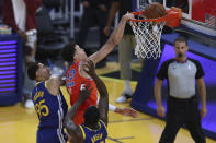 Oklahoma City Thunder's Isaiah Roby, center, shoots against Golden State Warriors' Draymond Green, right, and Juan Toscano-Anderson, left, during the first half of an NBA basketball game in San Francisco, Saturday, May 8, 2021. (AP Photo/Jed Jacobsohn)