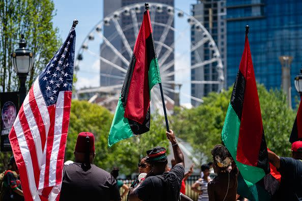 atlanta, ga june 18 people raise american and pan african flags while marching in the juneteenth atlanta black history parade on june 18, 2022 in atlanta, united statesjuneteenth, or emancipation day, commemorates the end of chattel slavery on june 19, 1865 in galveston, texas, in compliance with president lincolns 1863 emancipation proclamation in 2021, us president joe biden signed a law declaring juneteenth a federal holiday photo by elijah nouvelagegetty images