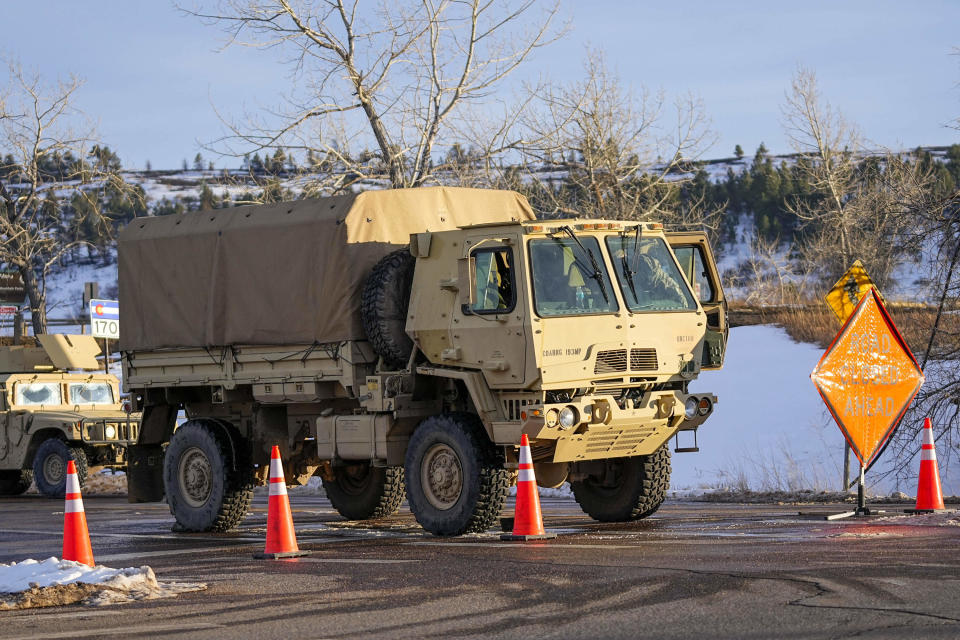 Members of the Colorado National Guard man a road block near the suspected origin of the Marshall wildfire Monday, Jan. 3, 2022, in Boulder, Colo. (AP Photo/Jack Dempsey)