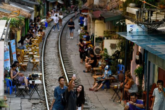 A family takes a selfie on Hanoi's popular Train Street on June 9, 2019.<span class="copyright">Manan Vatsyayana—AFP/Getty Images</span>