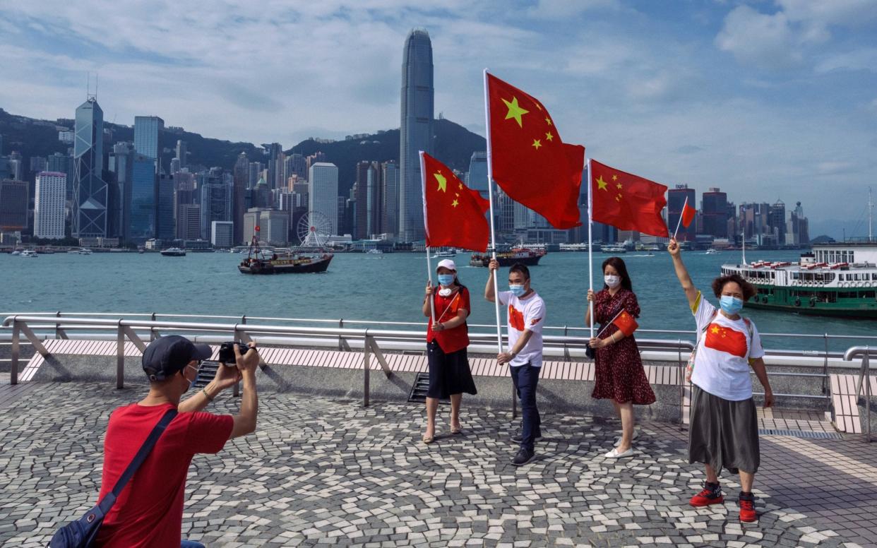 Pro-China supporters display People's Republic of China flags to mark China's National Day in Hong Kong - Billy H.C. Kwok /Getty Images AsiaPac 