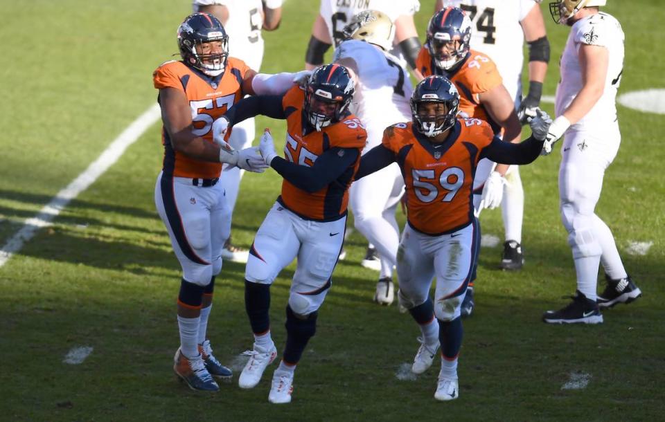 Nov 29, 2020; Denver, Colorado, USA; Denver Broncos outside linebacker Bradley Chubb (55) celebrates his sack with outside linebacker Malik Reed (59) and defensive end DeMarcus Walker (57) in the first quarter against the New Orleans Saints at Empower Field at Mile High. Mandatory Credit: Ron Chenoy-USA TODAY Sports