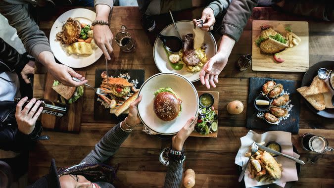 Friends all together at restaurant having meal - Image.