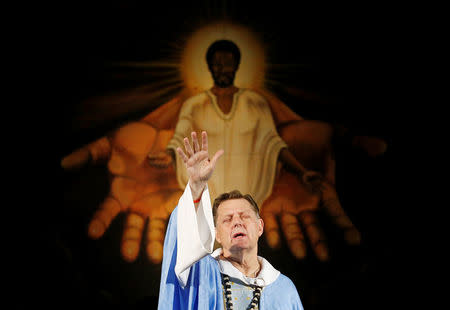 Father Michael Pfleger prays during a Sunday Service at Saint Sabina Church in Chicago, Illinois, U.S., December 4, 2016. REUTERS/Jim Young