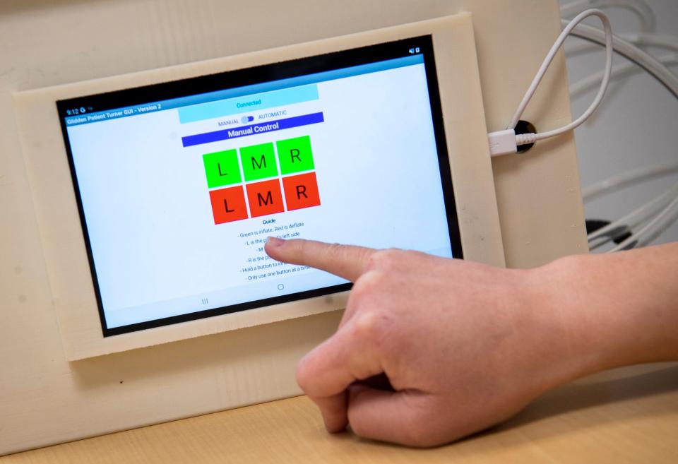 Morgan Miller points out the options for manual settings for the Morganleigh, a medical device that assists in moving bedridden patients, on Wednesday, Feb 8, 2023.