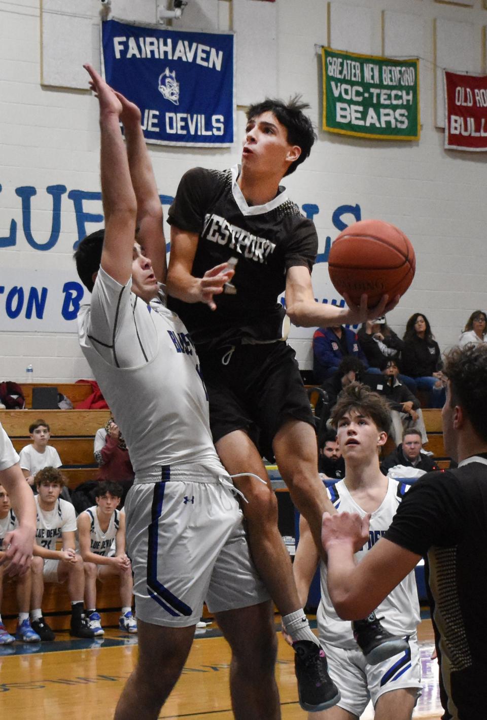 Westport's Owen Boudria goes up for a shot with Fairhaven's Jack Cunha defending.