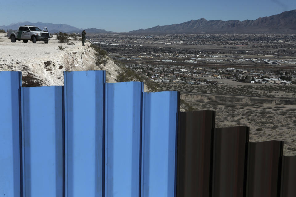 FILE - In this Jan. 25, 2017, file photo, an agent from the border patrol, observes near the Mexico-US border fence, on the Mexican side, separating the towns of Anapra, Mexico and Sunland Park, N.M. An 8-year-old boy from Guatemala died in government custody early Tuesday, Dec. 25, 2018, U.S. immigration authorities said. (AP Photo/Christian Torres, File)