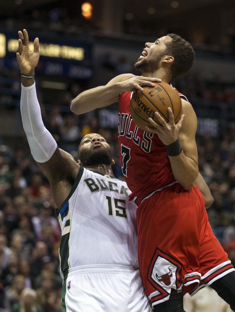 Chicago Bulls' Michael Carter-Williams, right, is fouled by Milwaukee Bucks' Greg Monroe during the second half of an NBA basketball game Sunday, March 26, 2017, in Milwaukee. (AP Photo/Tom Lynn)