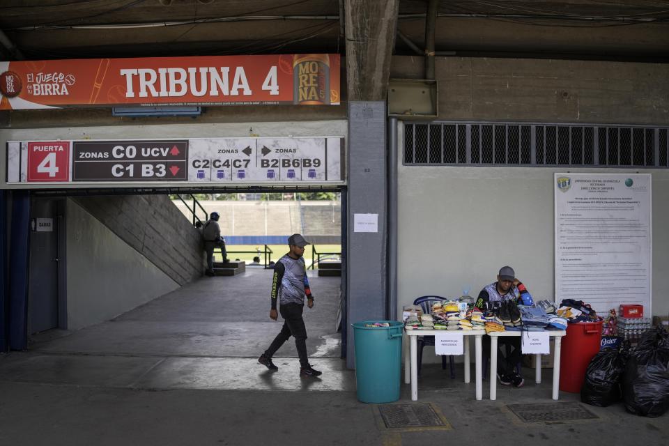 Volunteers from the baseball team Los Leones del Caracas wait for donations of clothes and food for those affected by flooding and a massive landslide, at their stadium in Caracas, Venezuela, Tuesday, Oct. 11, 2022. A landslide on Saturday night killed dozens in the town of Las Tejerías and left many homeless. (AP Photo/Matias Delacroix)