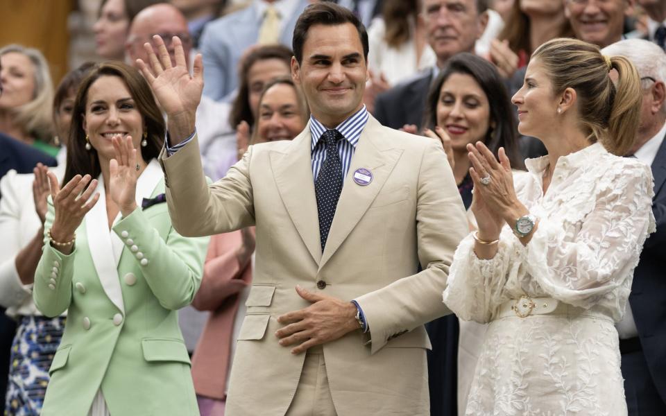 Roger Federer acknowledges the crowd alongside the Princess of Wales and his wife Mirka Federer