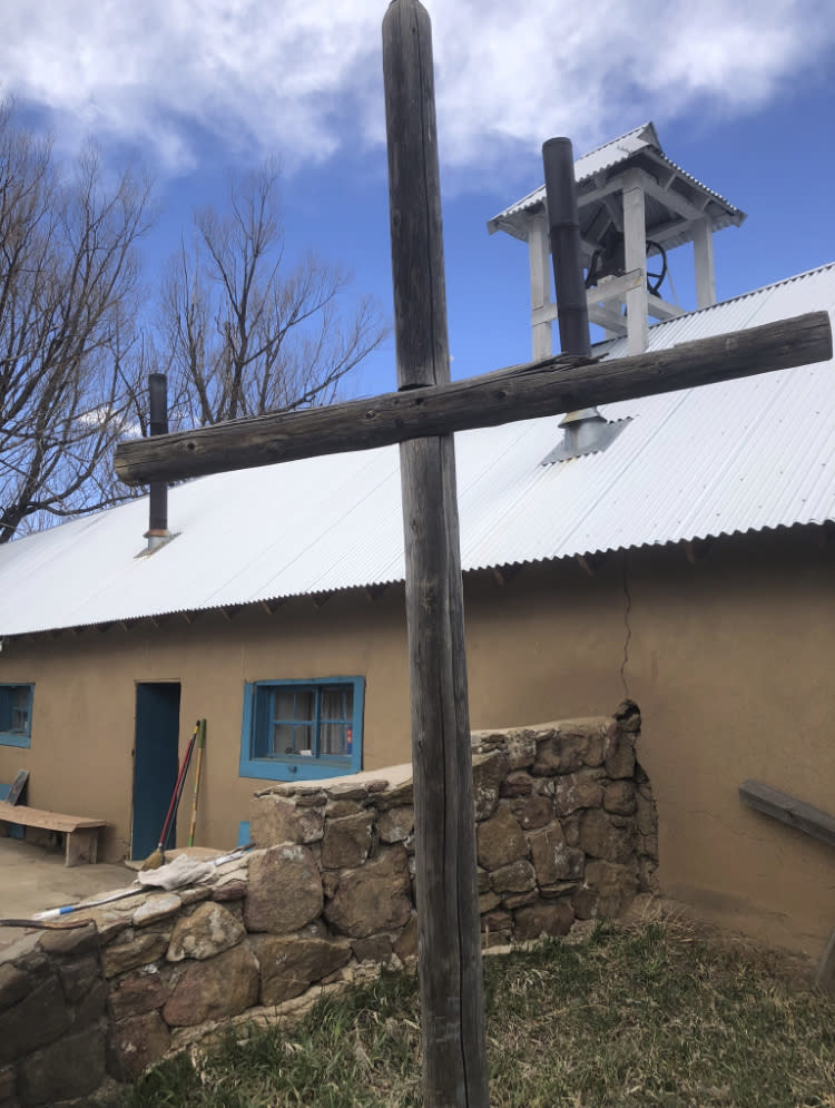 This April 2, 2021, photo provided by Fidel Trujillo shows the exterior of the San Isidro morada, a meeting space for a Catholic brotherhood, in Holman, New Mexico. Residents of the community were forced to evacuate because of a wildfire that has marched across 258 square miles of high alpine forest and grasslands at the southern tip of the Rocky Mountains. (Fidel Trujillo via AP)