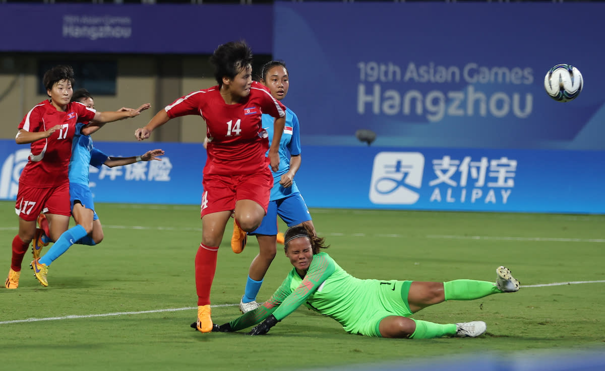 North Korea's Hong Son-gok (red jersey No.14) scoring their first goal against Singapore in their women's football group-stage match at the 2023 Hangzhou Asian Games. (PHOTO Sport Singapore/Jeremy Lee)