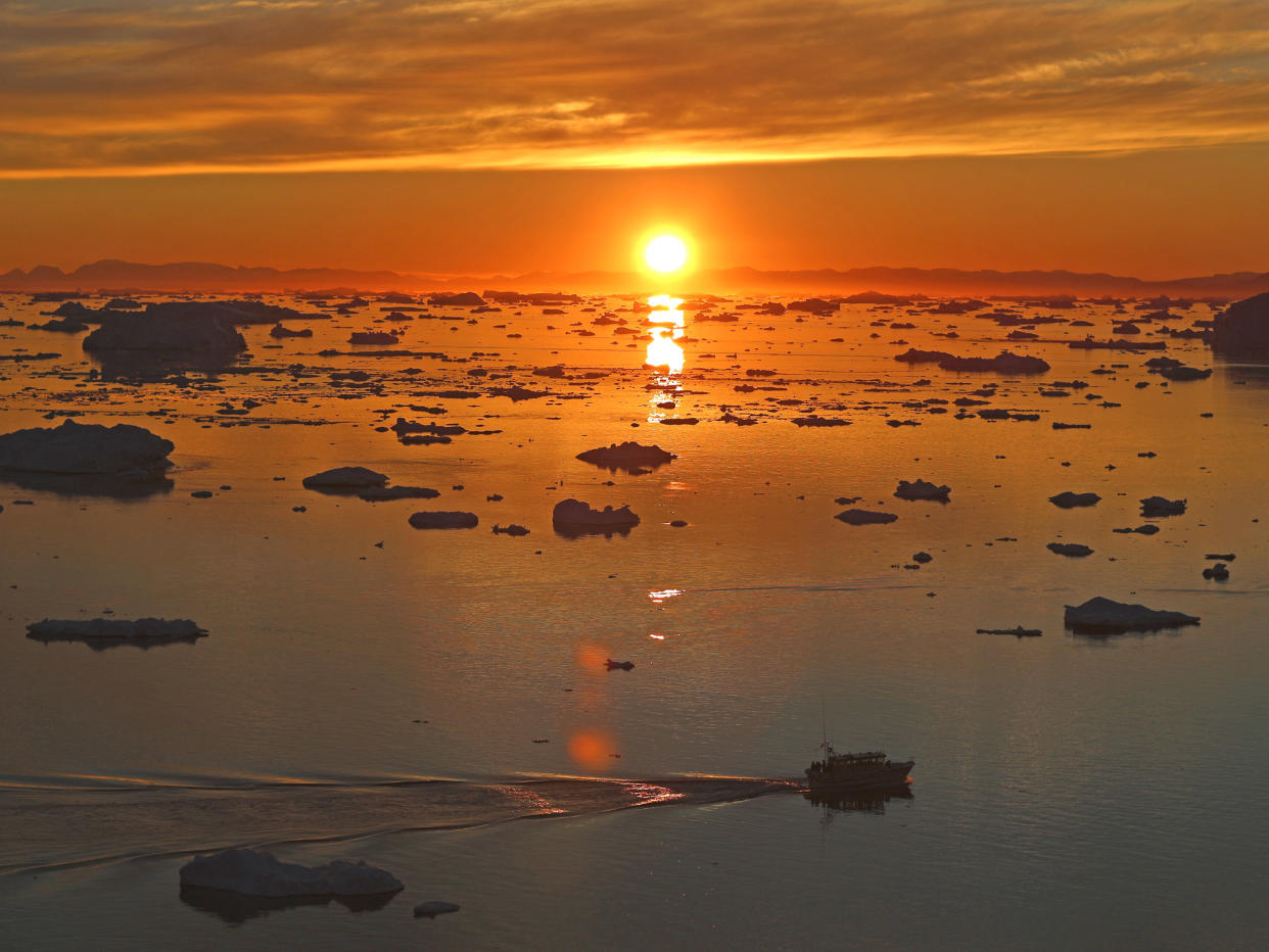 The sun sets over icebergs near Ilulissat in Greenland: Getty Images