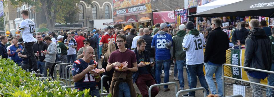 Football fans buy food from vendors before the Green Bay Packers-New York Giants game at Tottenham Hotspur Stadium. Tailgating, as it is known by Packers fans, doesn't exist.