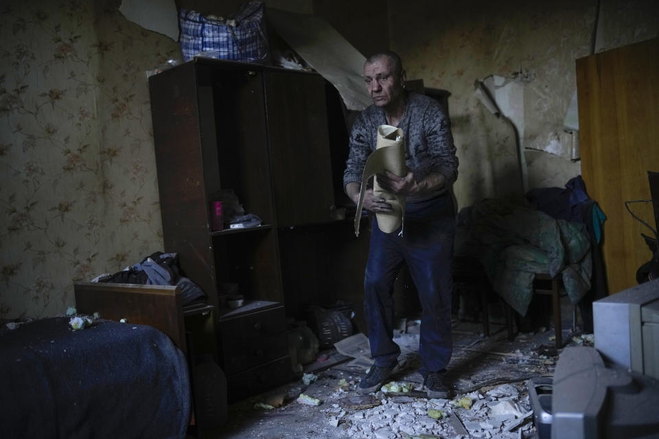 A local resident gathers up belongings from his heavily damaged house after a Russian strike in Pokrovsk, eastern Ukraine, Wednesday, May 25, 2022. Two rockets struck the eastern Ukrainian town of Pokrovsk, in the Donetsk region early Wednesday morning, causing at least four injuries. (AP Photo/Francisco Seco)