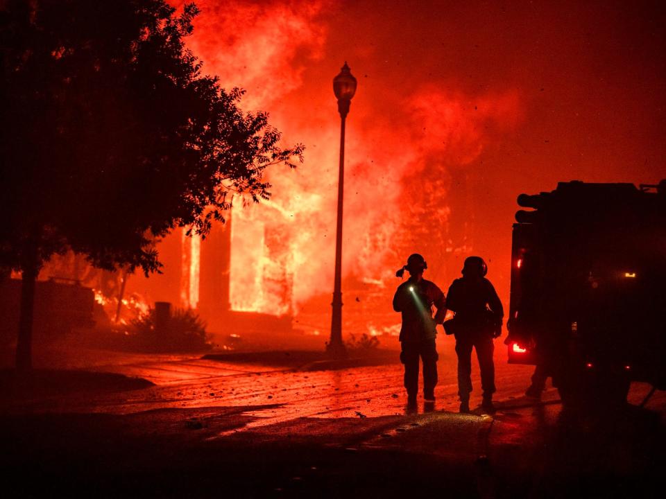 Firefighters near a home on fire in Santa Rosa in 2020.