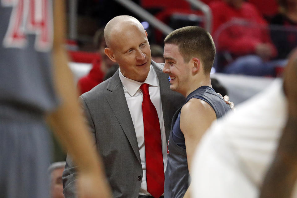 Louisville head coach Chris Mack congratulates Ryan McMahon (30) during the closing minutes of the second half of an NCAA college basketball game against North Carolina State in Raleigh, N.C., Saturday, Feb. 1, 2020. (AP Photo/Karl B DeBlaker)