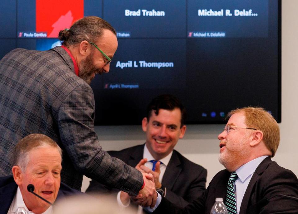 Wade Maki, chair of the UNC Faculty Assembly, shakes hands with UNC System President Peter Hans during a meeting of the UNC System Board of Governors on Thursday, Feb. 29, 2024, in Raleigh, N.C. Kaitlin McKeown/kmckeown@newsobserver.com