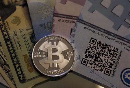 One of Bitcoin enthusiast Mike Caldwell's coins in this photo illustration at his office in Sandy, Utah, September 17, 2013. REUTERS/Jim Urquhart