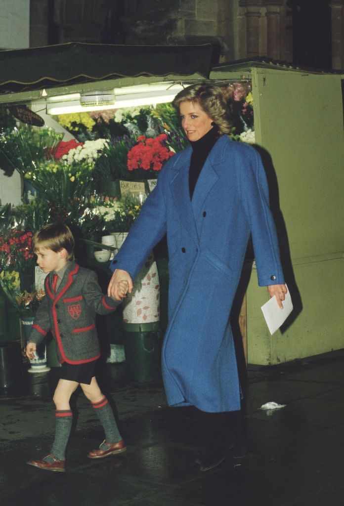 <p>Princess Di brings a uniformed Prince William to a Christmas concert in 1987. Her oversize blue wool coat covering an all-black ensemble likely sparked a wave of imitations, as many of her outfits did. </p>