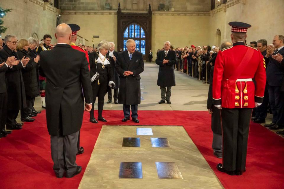 King Charles III visits the Houses of Parliament to see a new plaque commemorating Queen Elizabeth II laying in State in Westminster Hall on December 14, 2022.