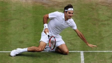 Britain Tennis - Wimbledon - All England Lawn Tennis & Croquet Club, Wimbledon, England - 8/7/16 Switzerland's Roger Federer lies on court after falling during his match against Canada's Milos Raonic REUTERS/Adam Davy/Pool