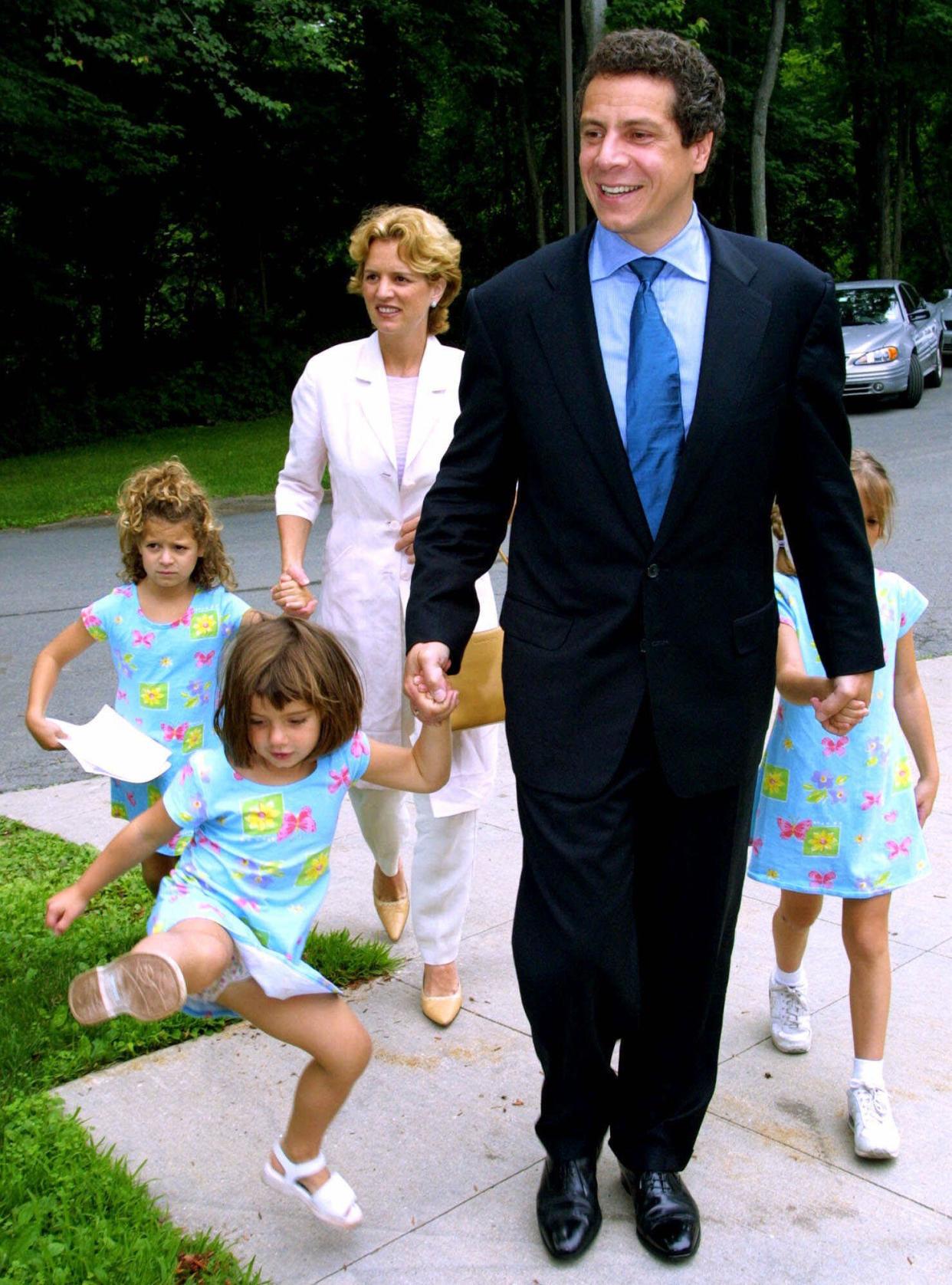 Former Housing Secretary Andrew Cuomo, center, arrives at the Byram Hills Central School District Administrative Offices with his wife, Kerry Kennedy Cuomo, and their daughters, Cara, 6-years-old, left, Michaela, 3-years-old, 2nd from left, and Mariah, right, Friday, June 22, 2001, in Armonk, N.Y. Cuomo enrolled his twin daughters in the first grade in the Byram Hills public school after buying a home in Westchester county.