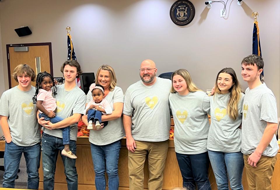 The Howards stand for a photo after the adoption of Aleah and Delilah during Ottawa County's Adoption Day on Tuesday, Nov. 22, 2022.