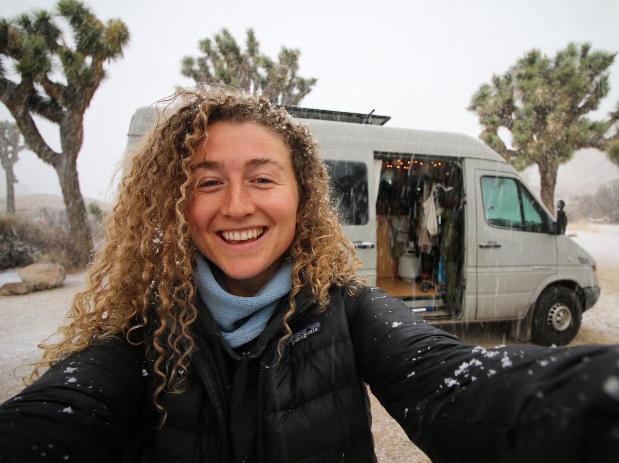 Kaya Lindsay smiling in front of van